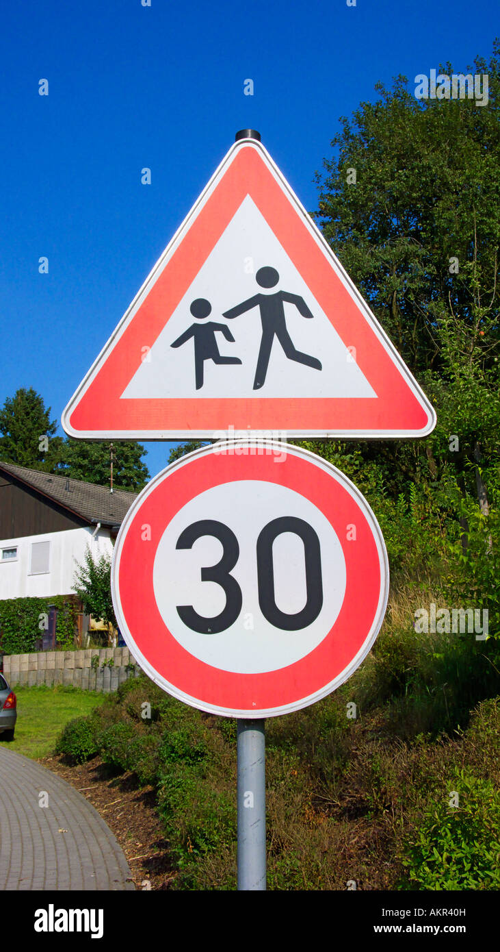traffic, automobile traffic, car traffic, transport, road signs, traffic signs, danger signs, attention, danger, caution, children, childs, speed limit, 30 kilometres per hour, thirty kilometers per hour, kph Stock Photo