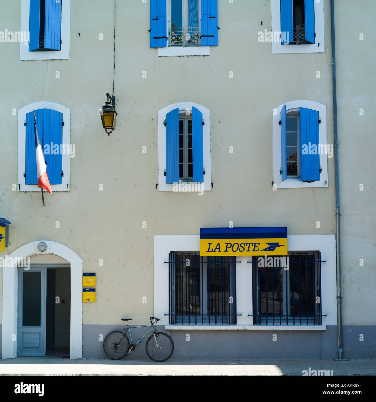 Post office, house with blue shutters, French flag, bike, Suzela