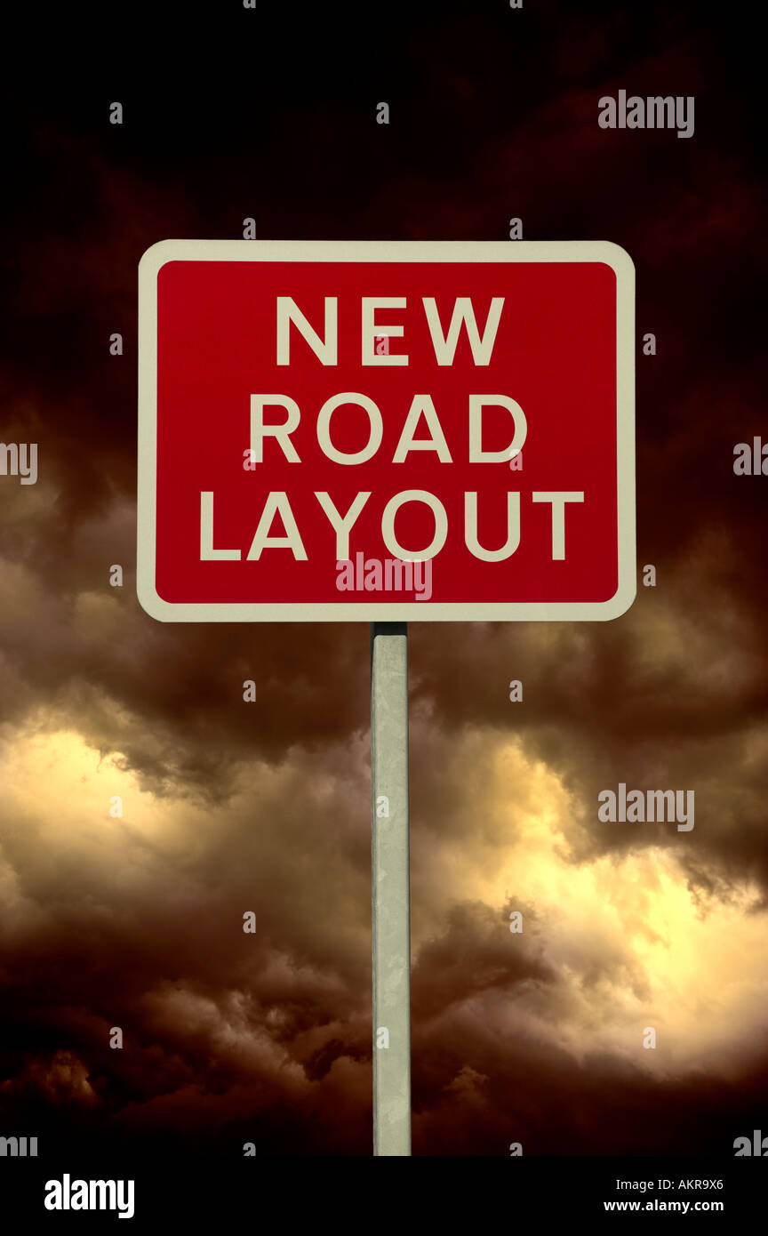 RED NEW ROAD LAYOUT WARNING SIGN WITH STORMY SKY AND CLOUDS IN BACKGROUND Stock Photo