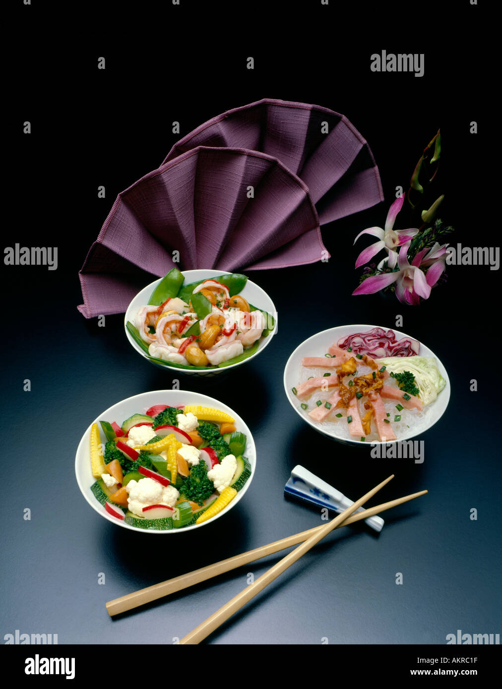 food photography of Japanese Chinese far eastern cuisine 3 plates with  napkin fan chop sticks Stock Photo - Alamy