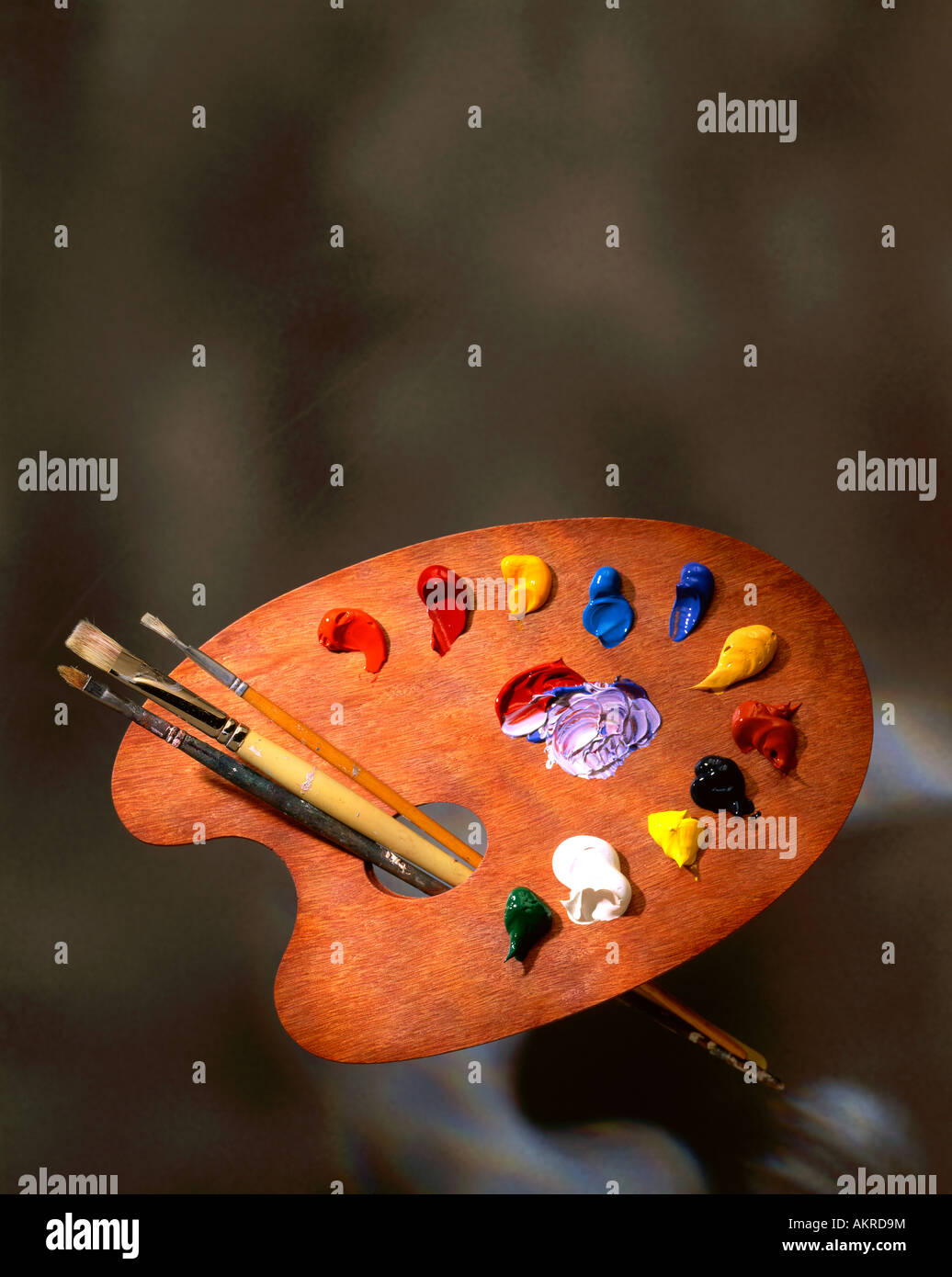 Artist's palette with paint and brushes Stock Photo