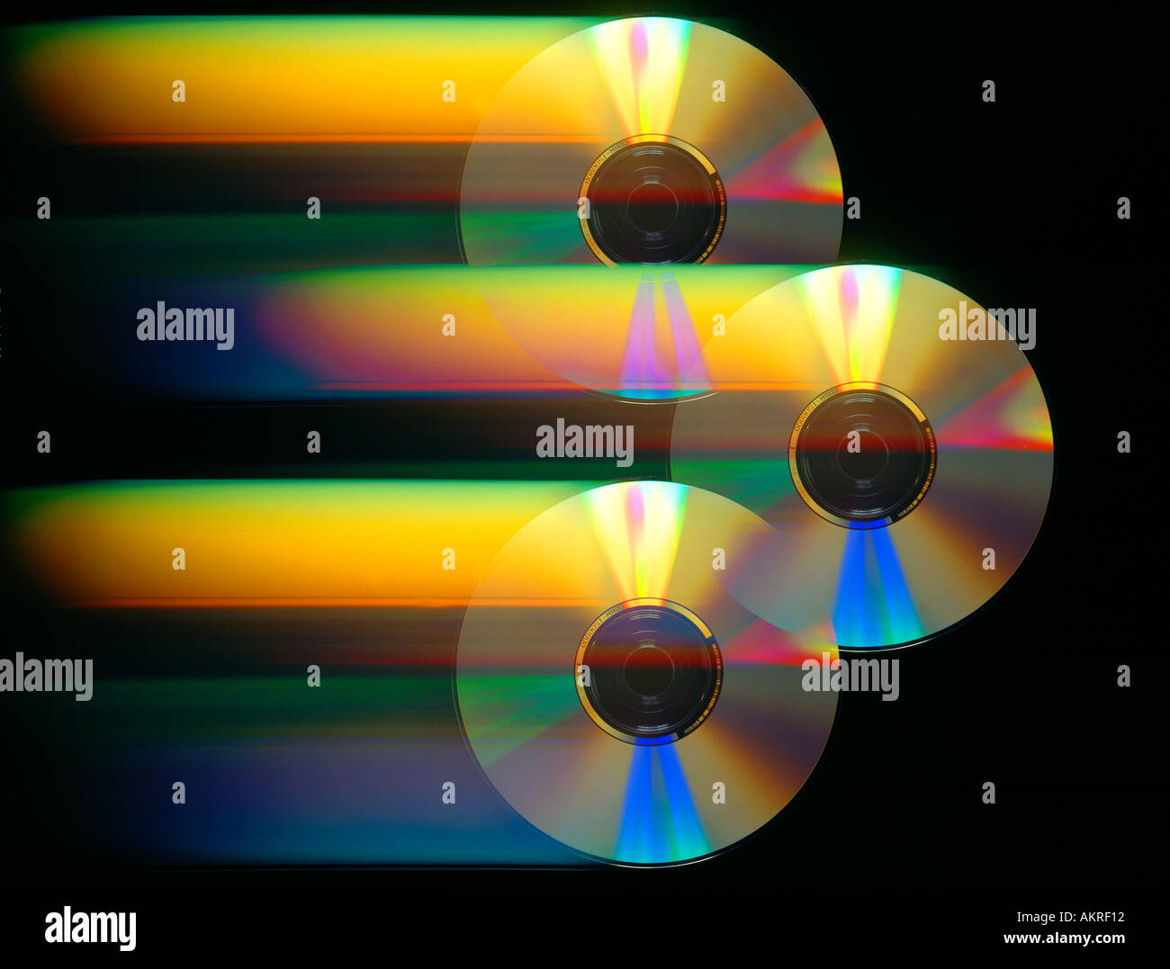 three CD ROM discs in motion with color Stock Photo Alamy