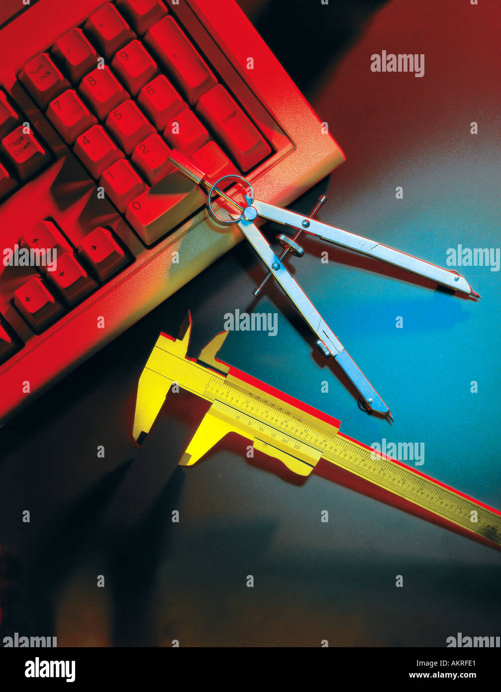 calipers and compass drafting tools with computer keyboard Stock Photo