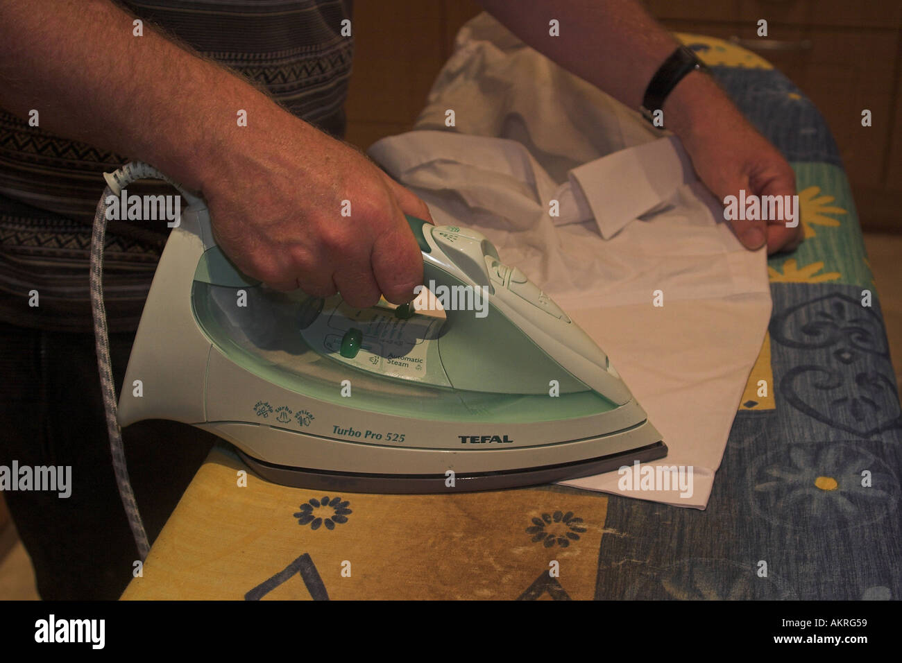 man ironing a shirt Stock Photo Alamy