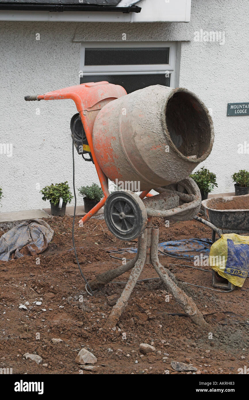 a cement mixer outside of a house Stock Photo Alamy