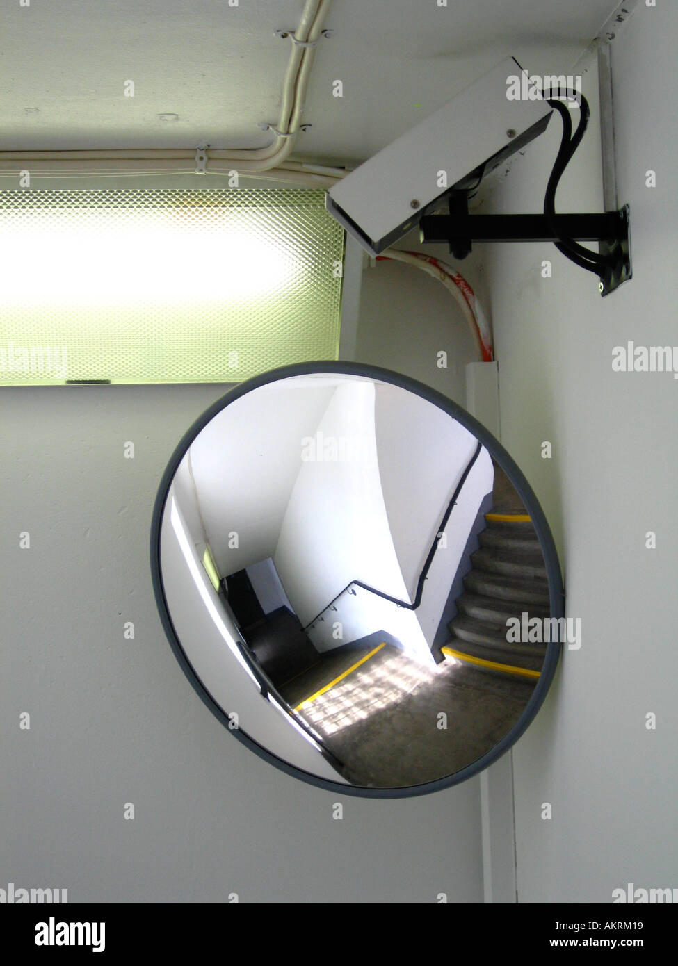 Security observation mirror and CCTV camera on stairway Stock Photo Alamy