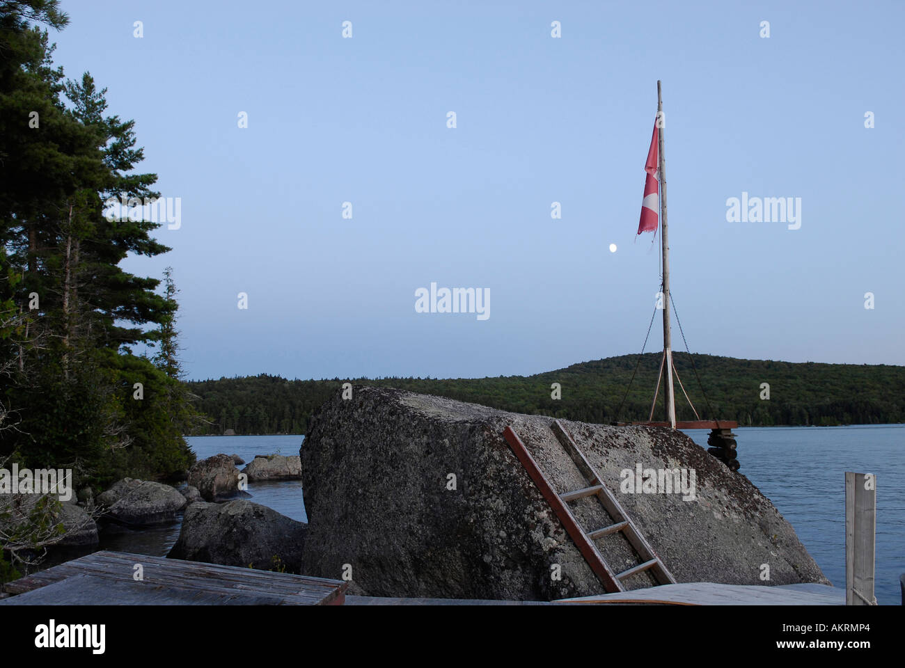 Stock image of an island on Skiff Lake with Flag in a huge rock with a