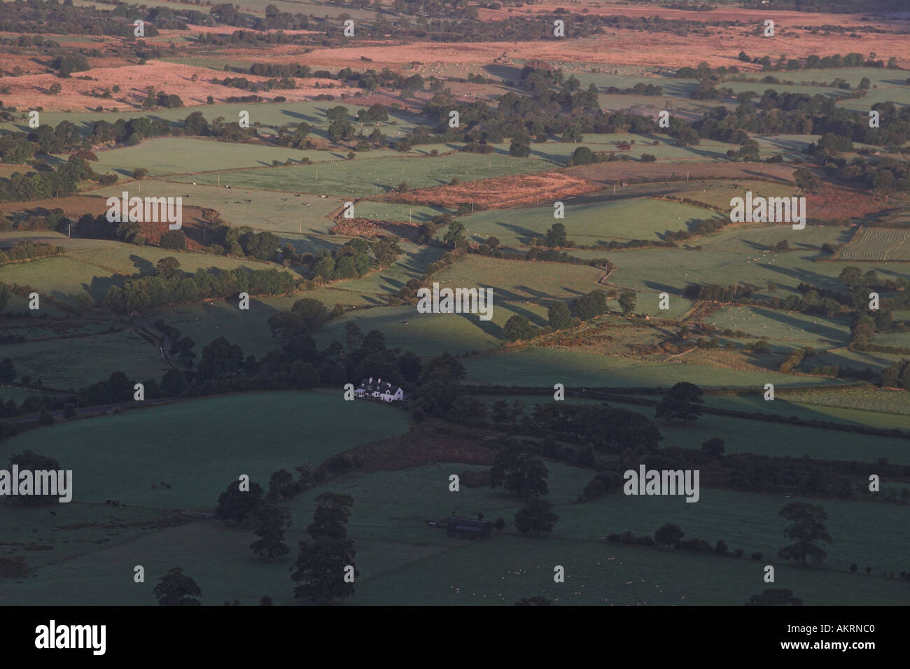 sunrise casting a shadow over fields in the lake district, cumbria, uk Stock Photo