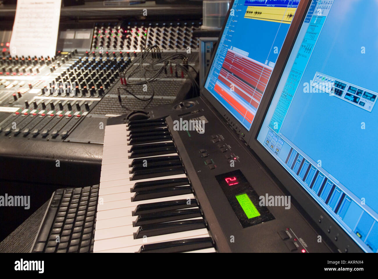 working in recording studio mixer unit and keybords with display in a