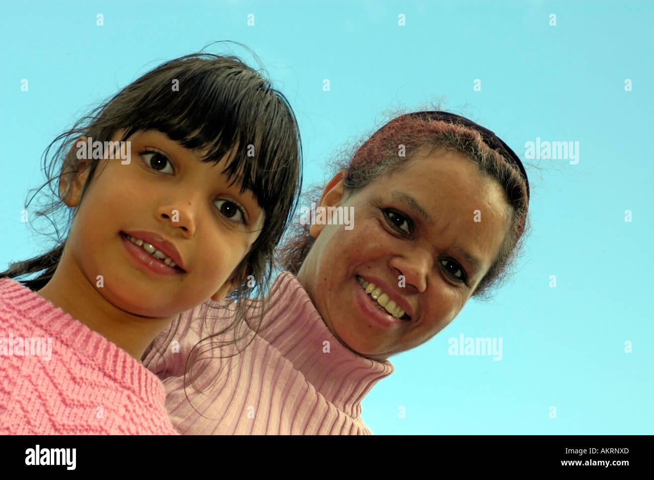 mother and daughter face of a woman and a girl swarthy dark skinned worm s eye view Stock Photo