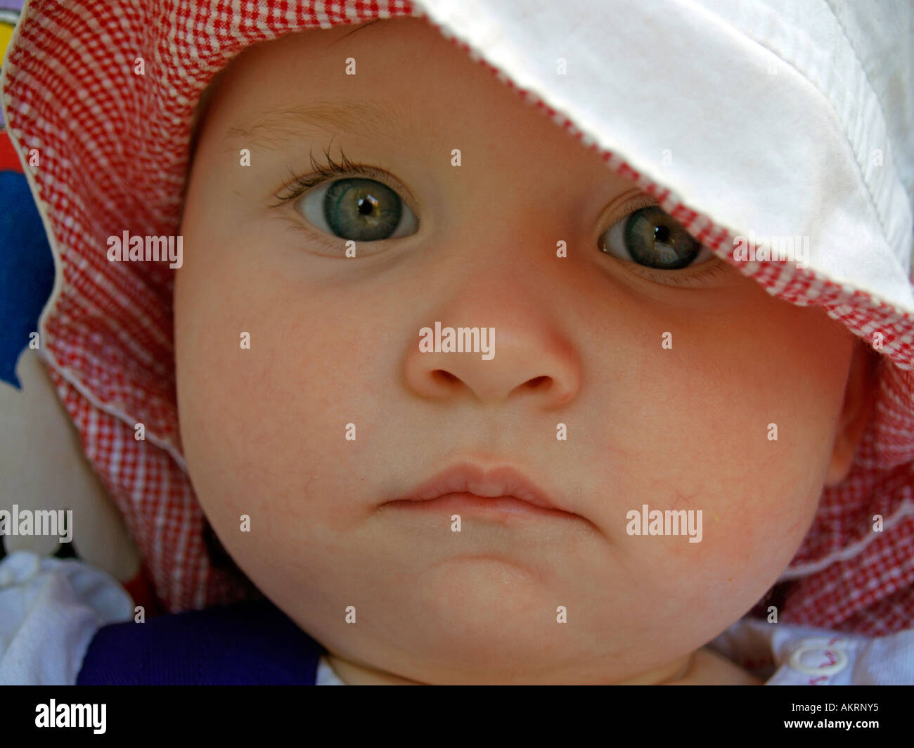 portrait of a baby of 8 months with sun hat Stock Photo