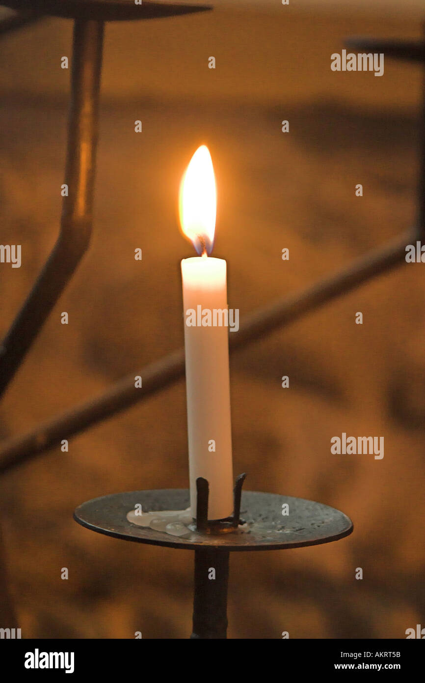 a candle lit in a church for remembrance, in cartmel, uk Stock Photo