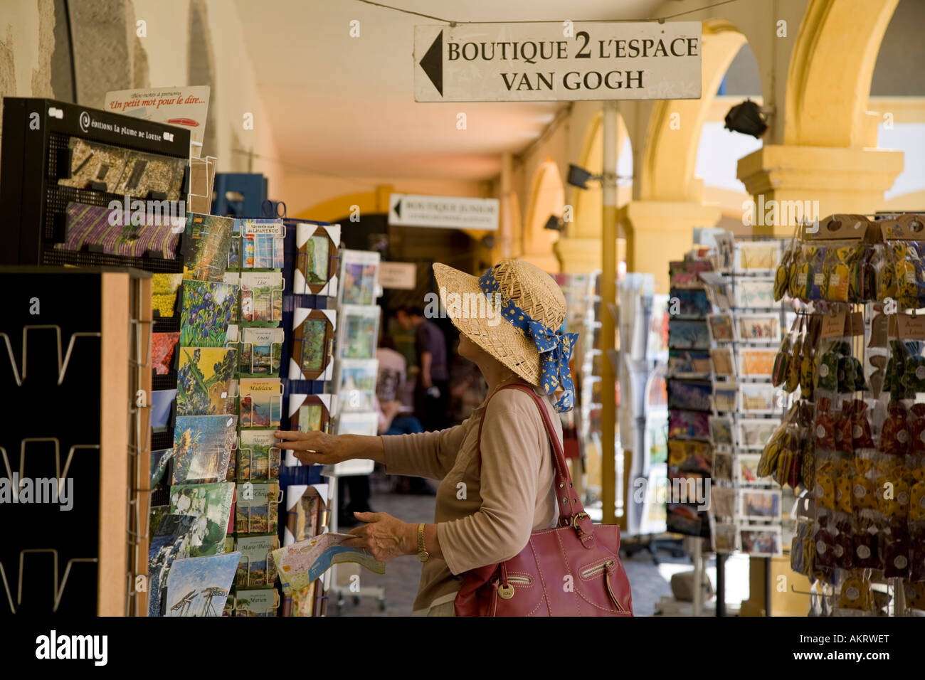 WOMAN TOURIST BUYING CARDS IN ARLES FRANCE Stock Photo