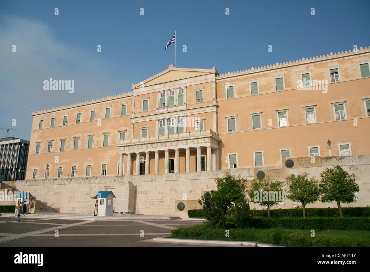 perspective view of greek parliament exterior horizontal shut with tourists and guards landmakrs of athens greece Stock Photo