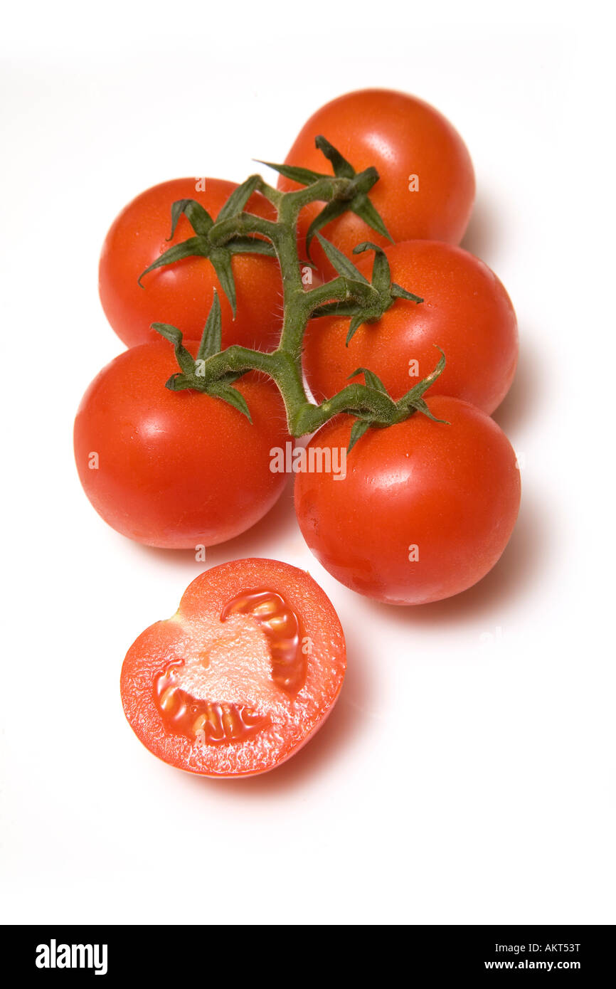 Vine tomatoes isolated on a white studio background Stock Photo - Alamy