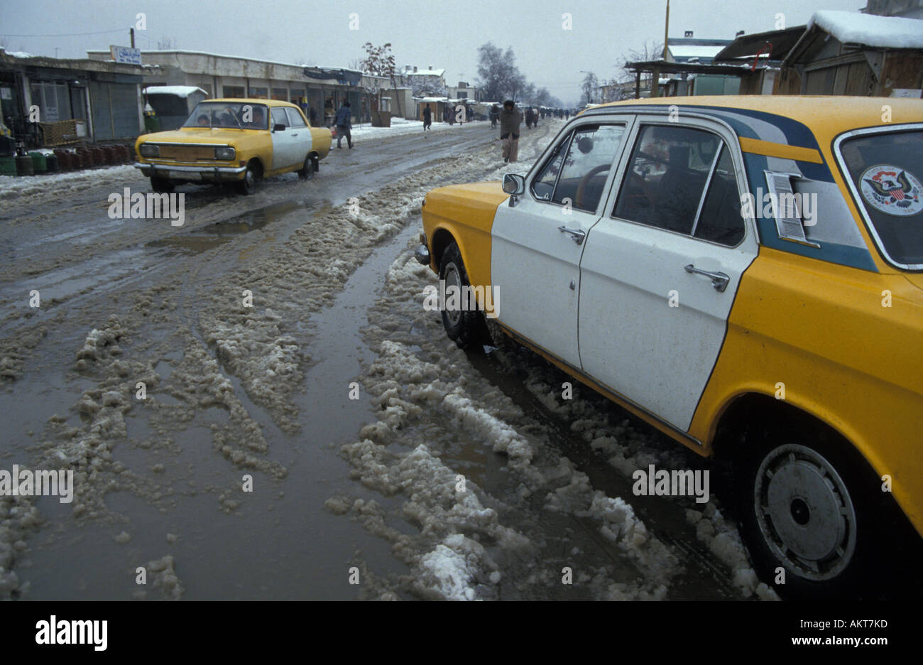 Afghan Russian made Volga taxis in snowy street Kabul Afghanistan Stock Photo