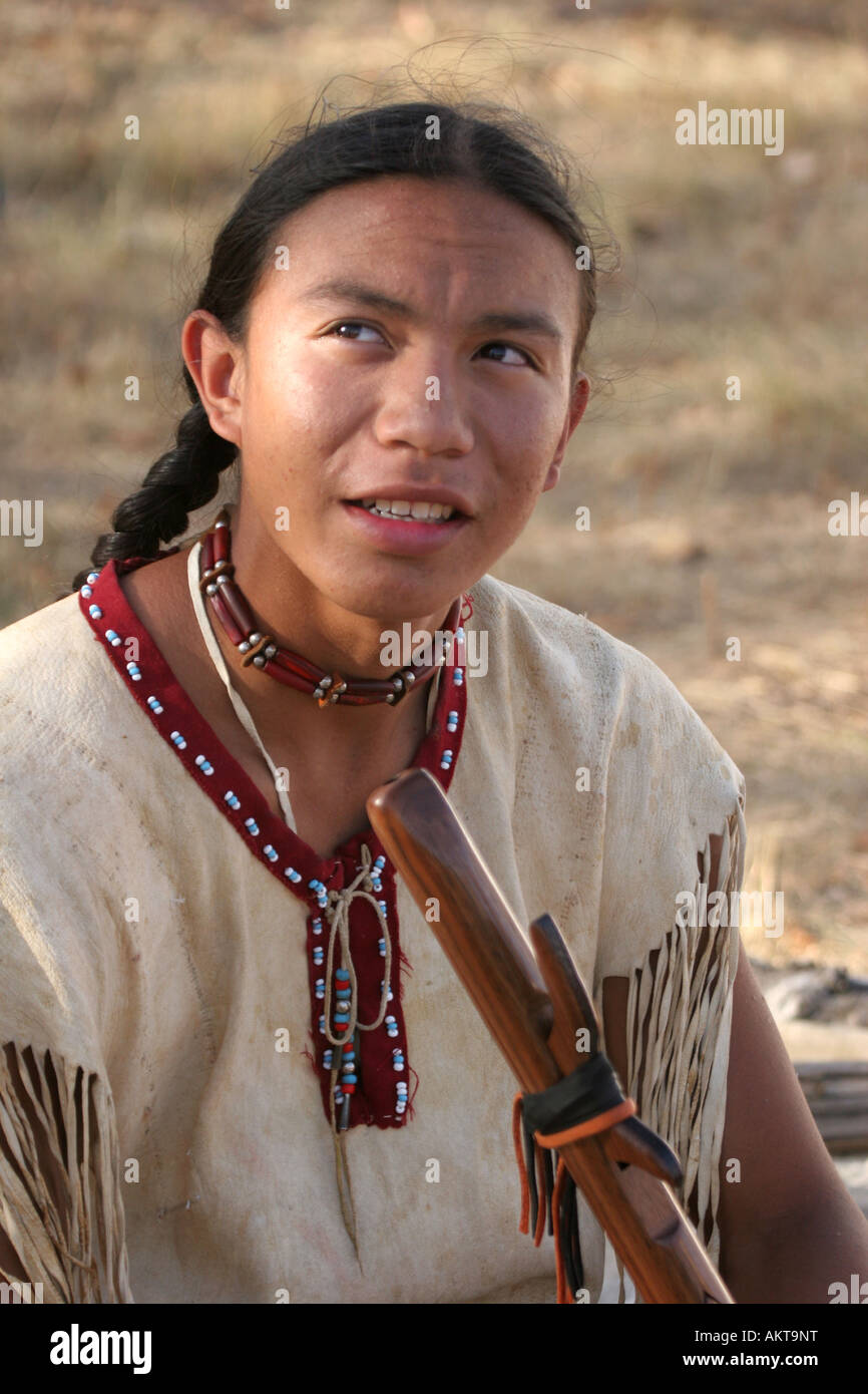 A Native American Indian boy holding a handcarved wooden flute Stock ...