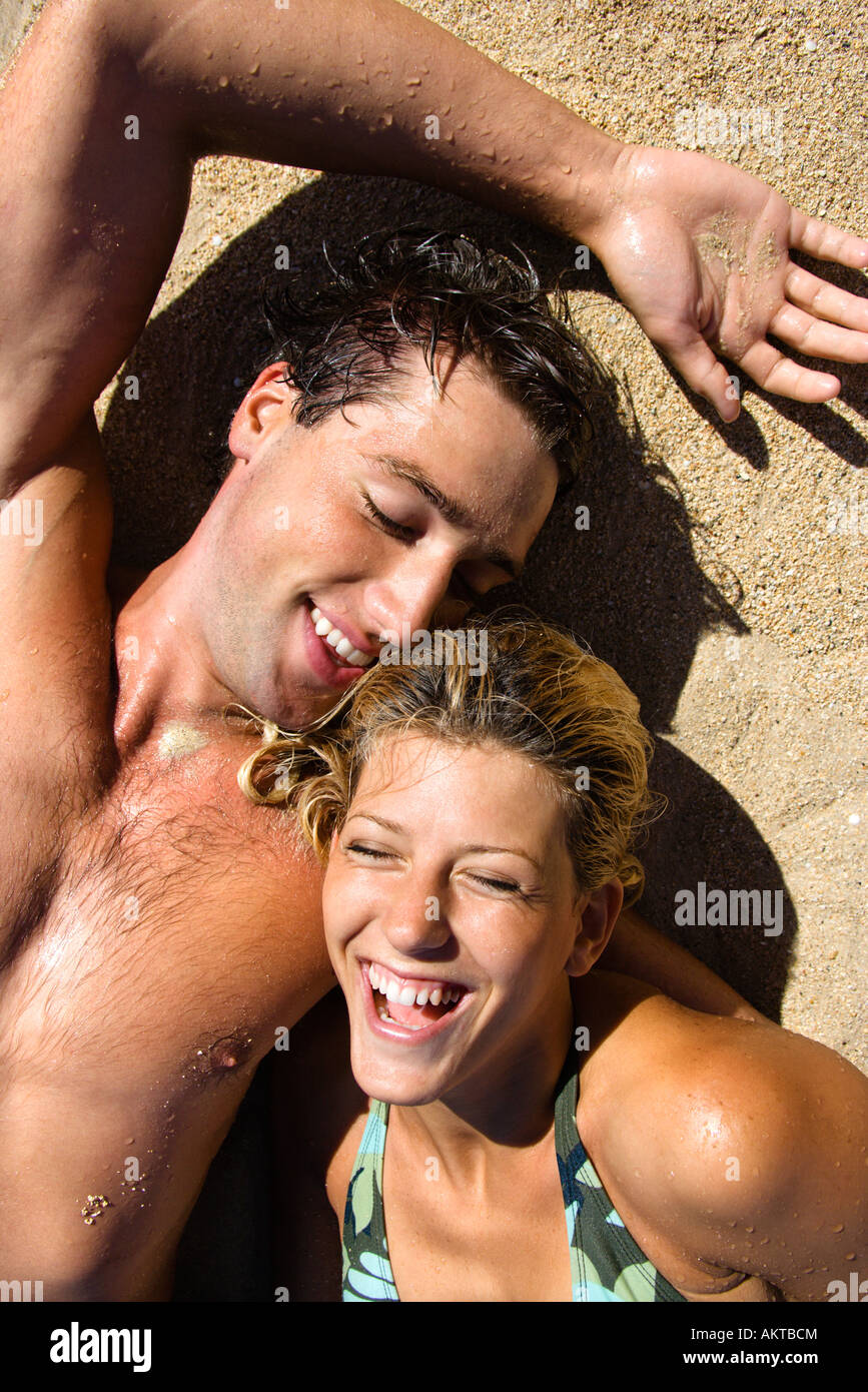 Young couple lying on beach hi-res stock photography and images - Alamy