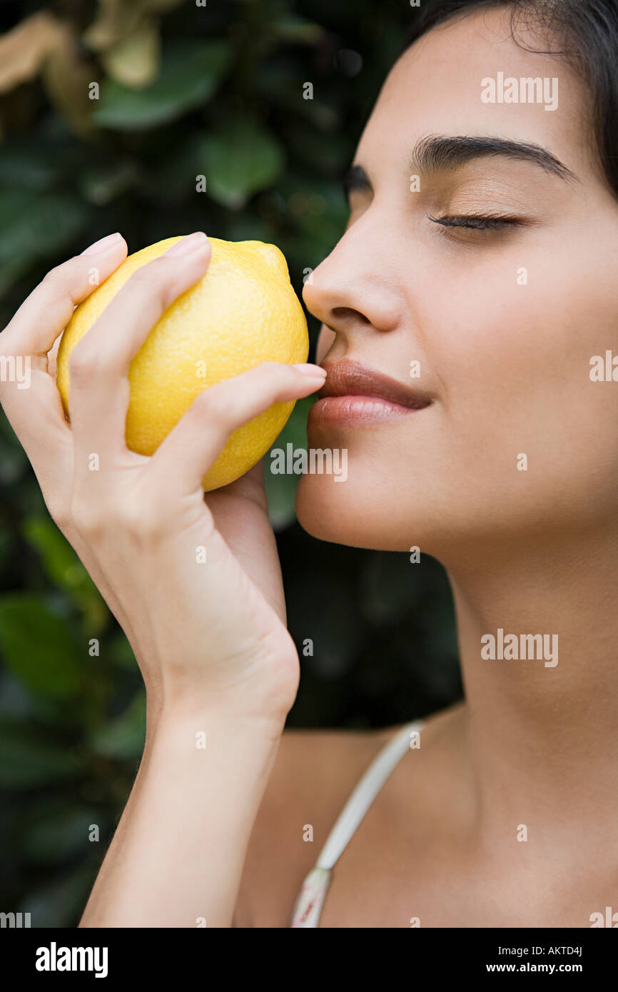 Woman smelling a lemon Stock Photo Alamy