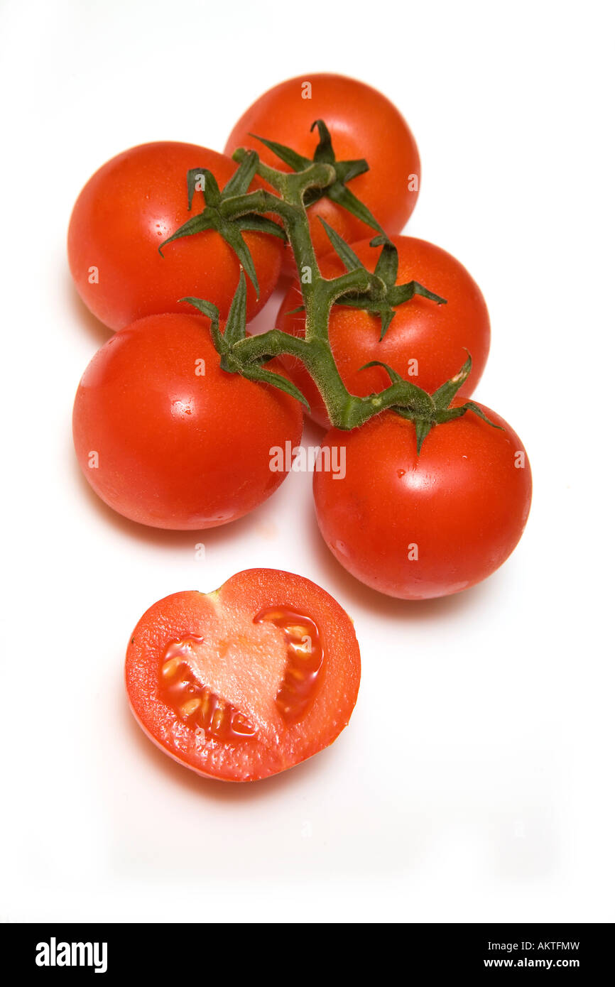 Vine tomatoes isolated on a white studio background Stock Photo - Alamy