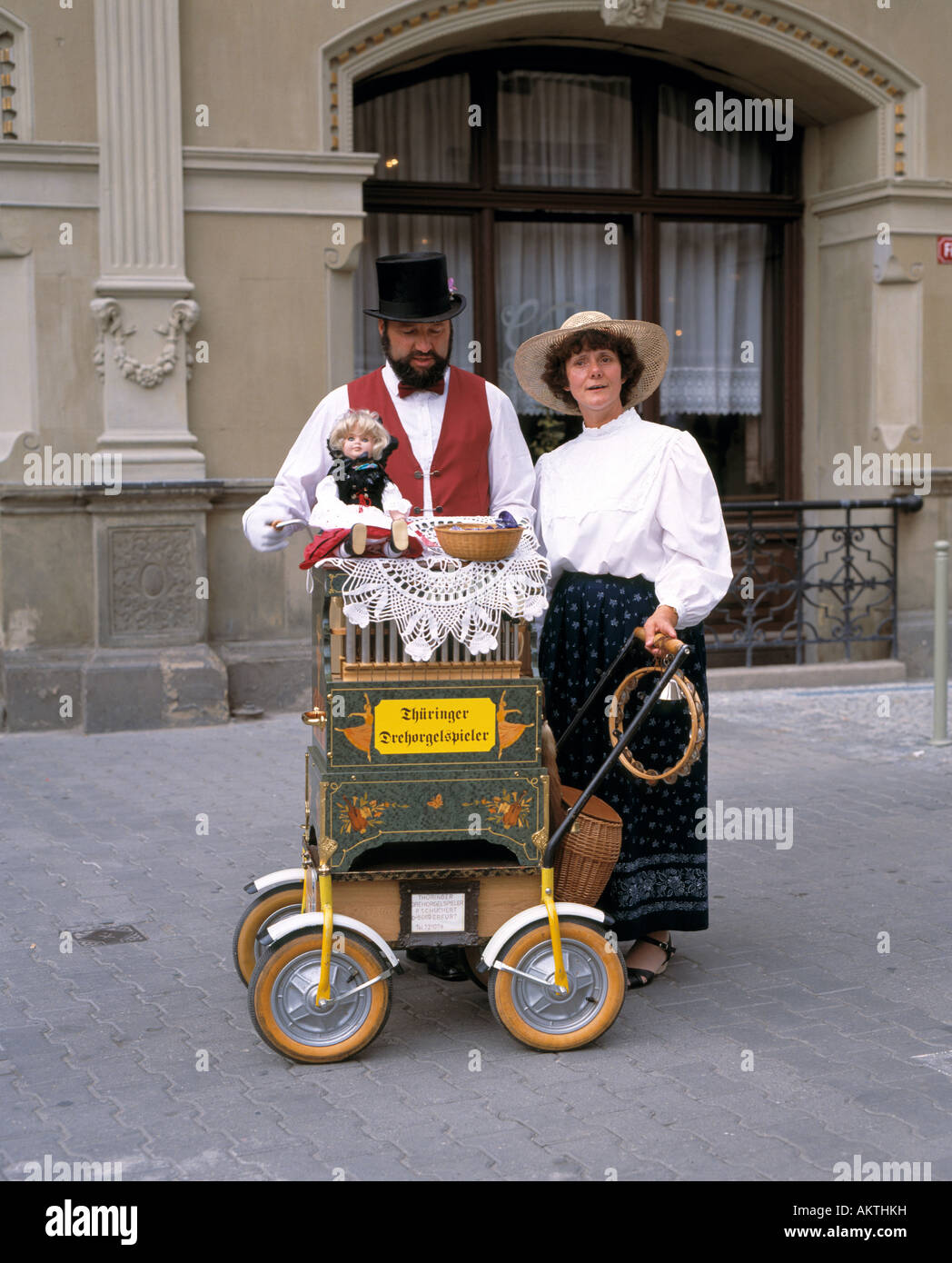 music, musician, Thuringian barrel organ player, organ grinder, couple, man and woman, husband and wife, top hat, waistcoat, vest, bow tie, blouse, skirt, long skirt, Fish Market Place in Erfurt, Thuringia Stock Photo