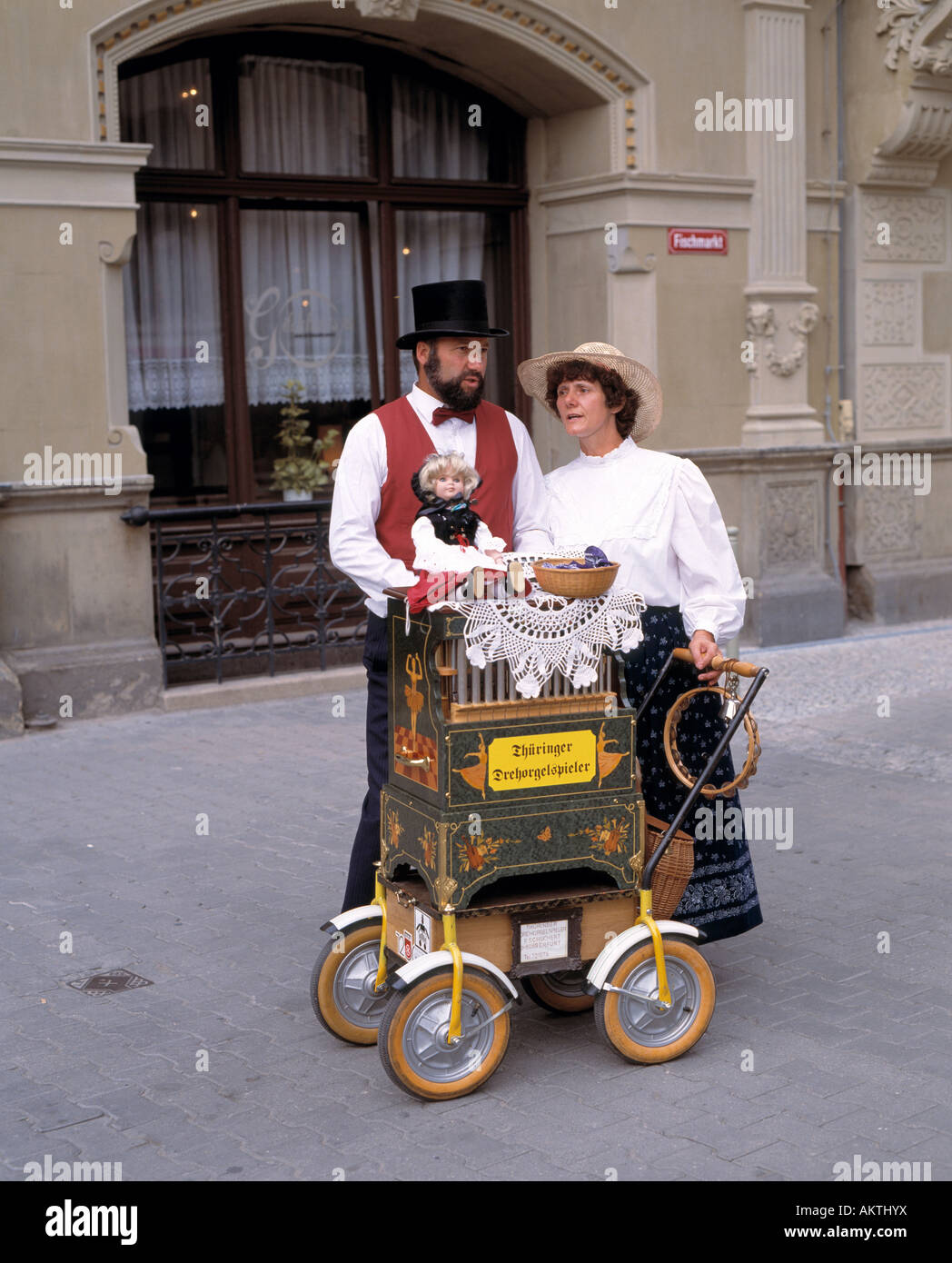 music, musician, Thuringian barrel organ player, organ grinder, couple, man and woman, husband and wife, top hat, waistcoat, vest, bow tie, blouse, skirt, long skirt, Fish Market Place in Erfurt, Thuringia Stock Photo