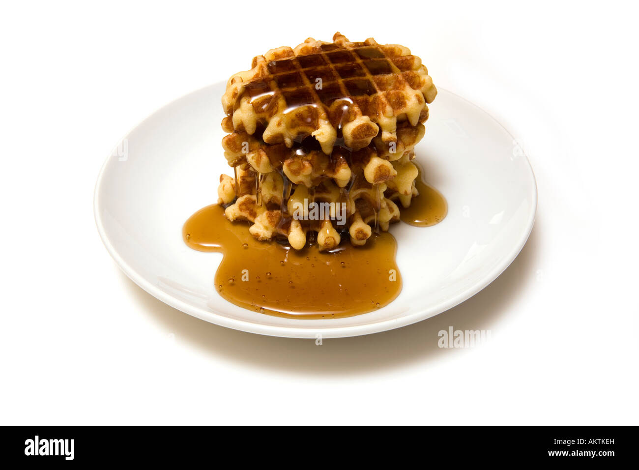 Belgian waffles with maple syrup isolated on a white studio background