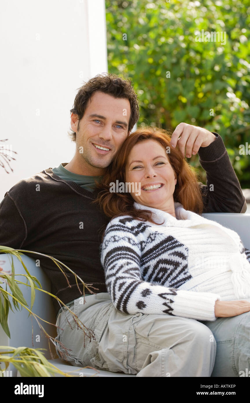 Couple sitting and relaxing, looking into camera Stock Photo