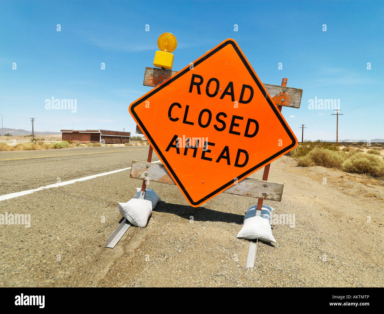 Road sign on rural highway warning that road is closed ahead Stock Photo