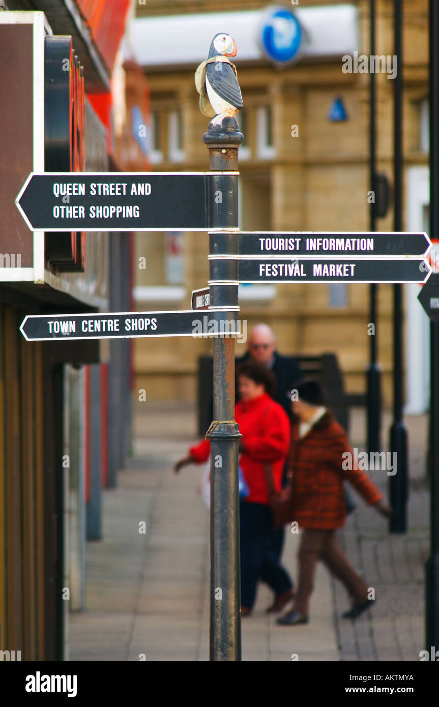 Shoppers and signpost in Morecambe Lancashire Stock Photo
