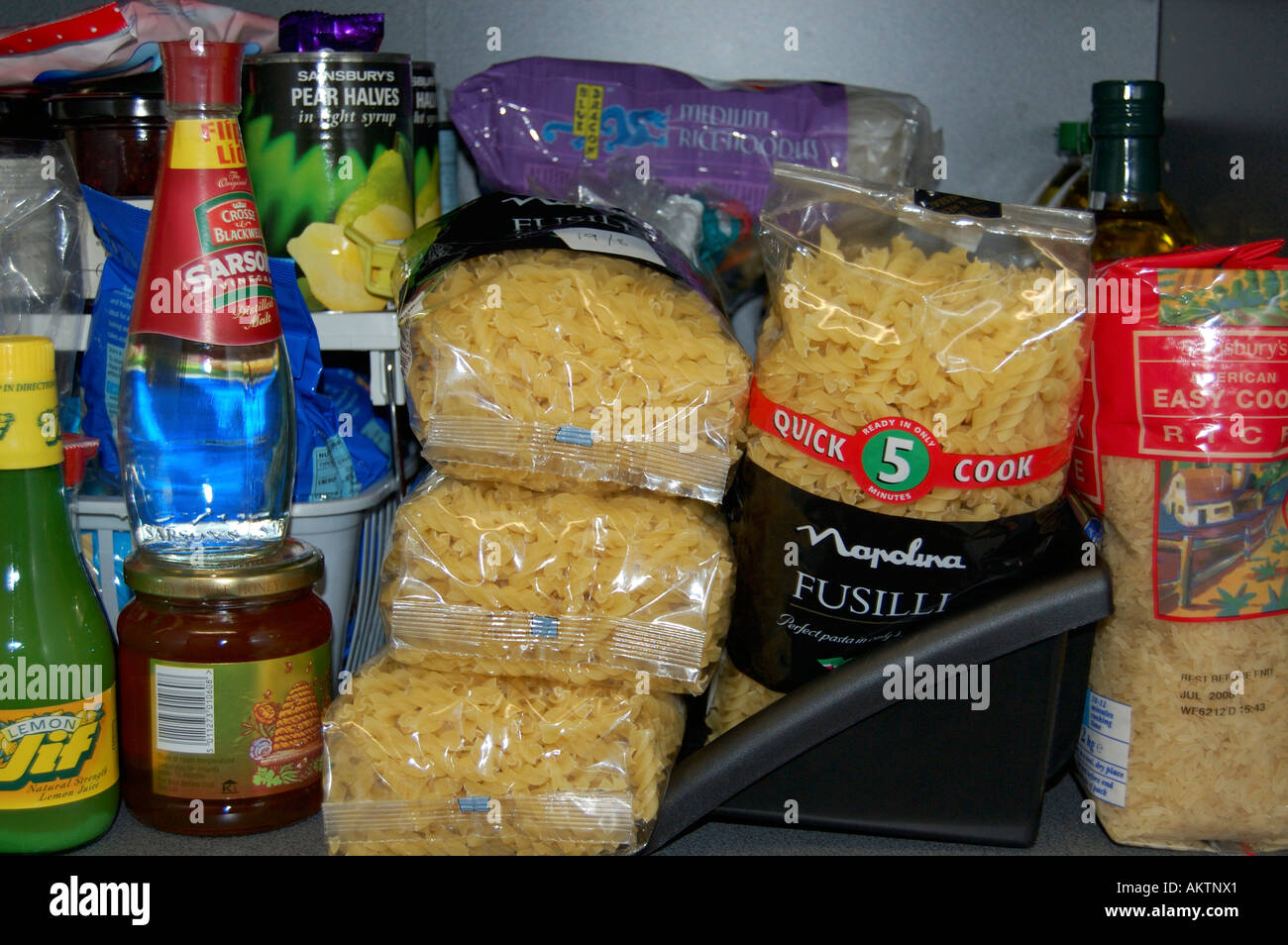Food on a shelf in a kitchen cupboard or pantry Stock Photo Alamy
