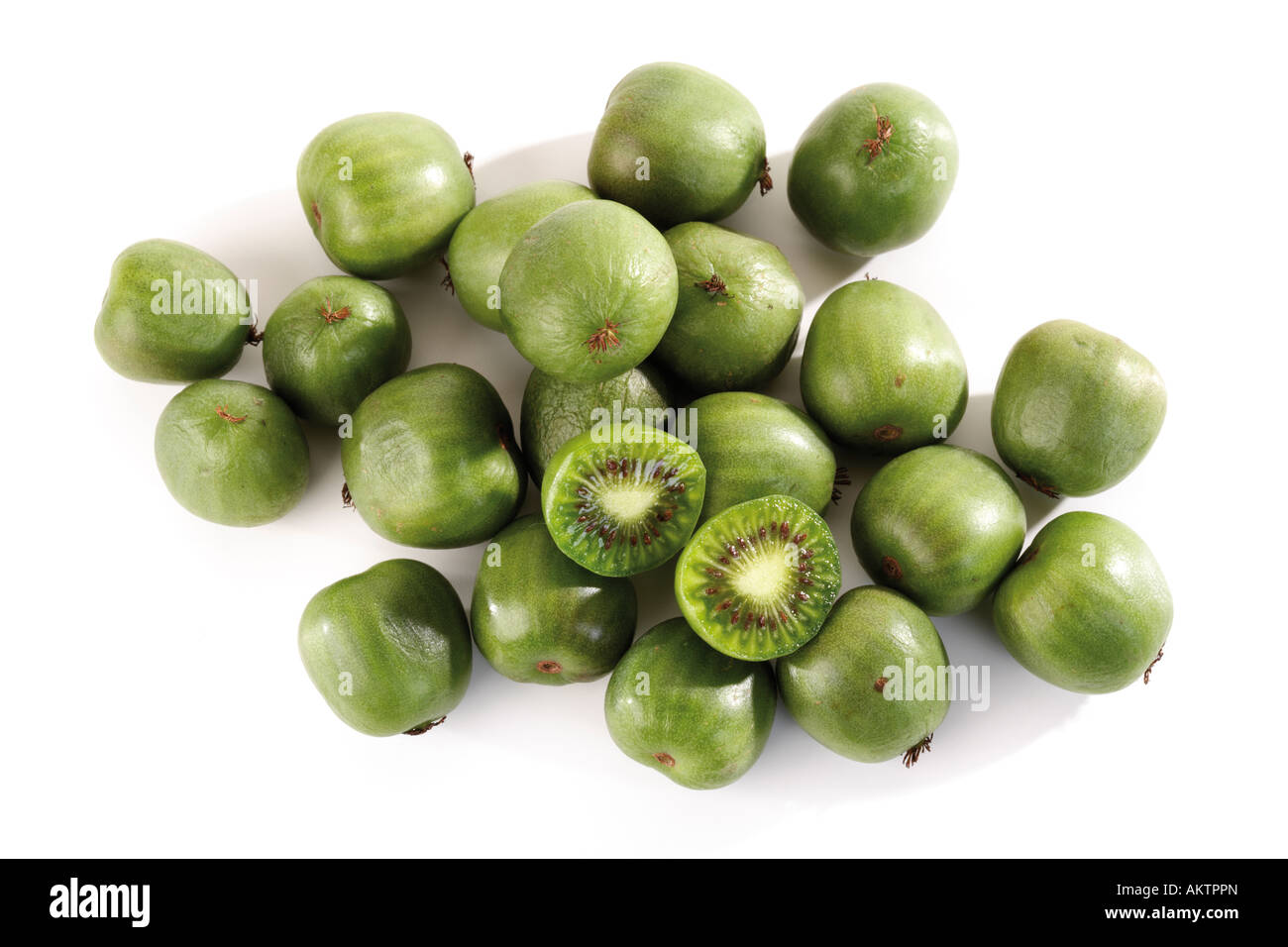 Whole and halved kiwi fruits, close-up Stock Photo