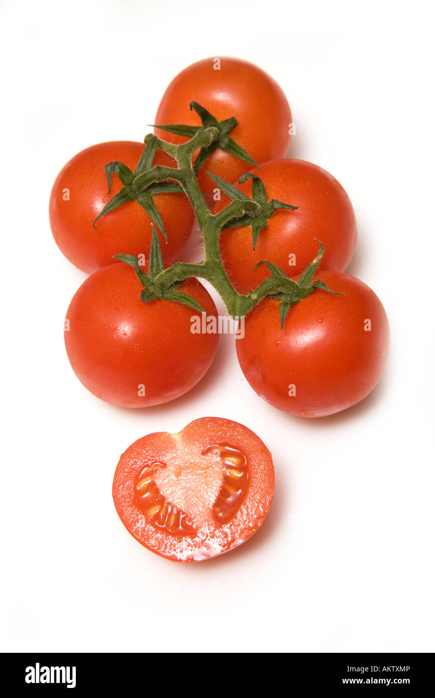 Vine tomatoes isolated on a white studio background Stock Photo - Alamy