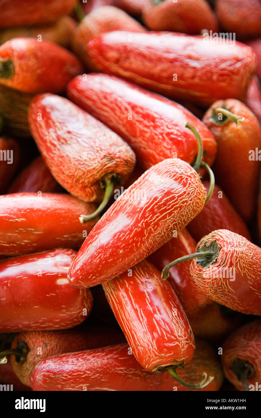Pile of red Serrano peppers at produce market Stock Photo