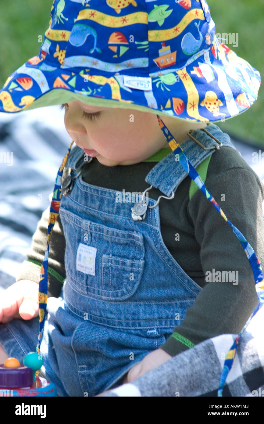 Baby wearing blue aquatic sun hat playing at Como Park. St Paul Minnesota MN USA Stock Photo