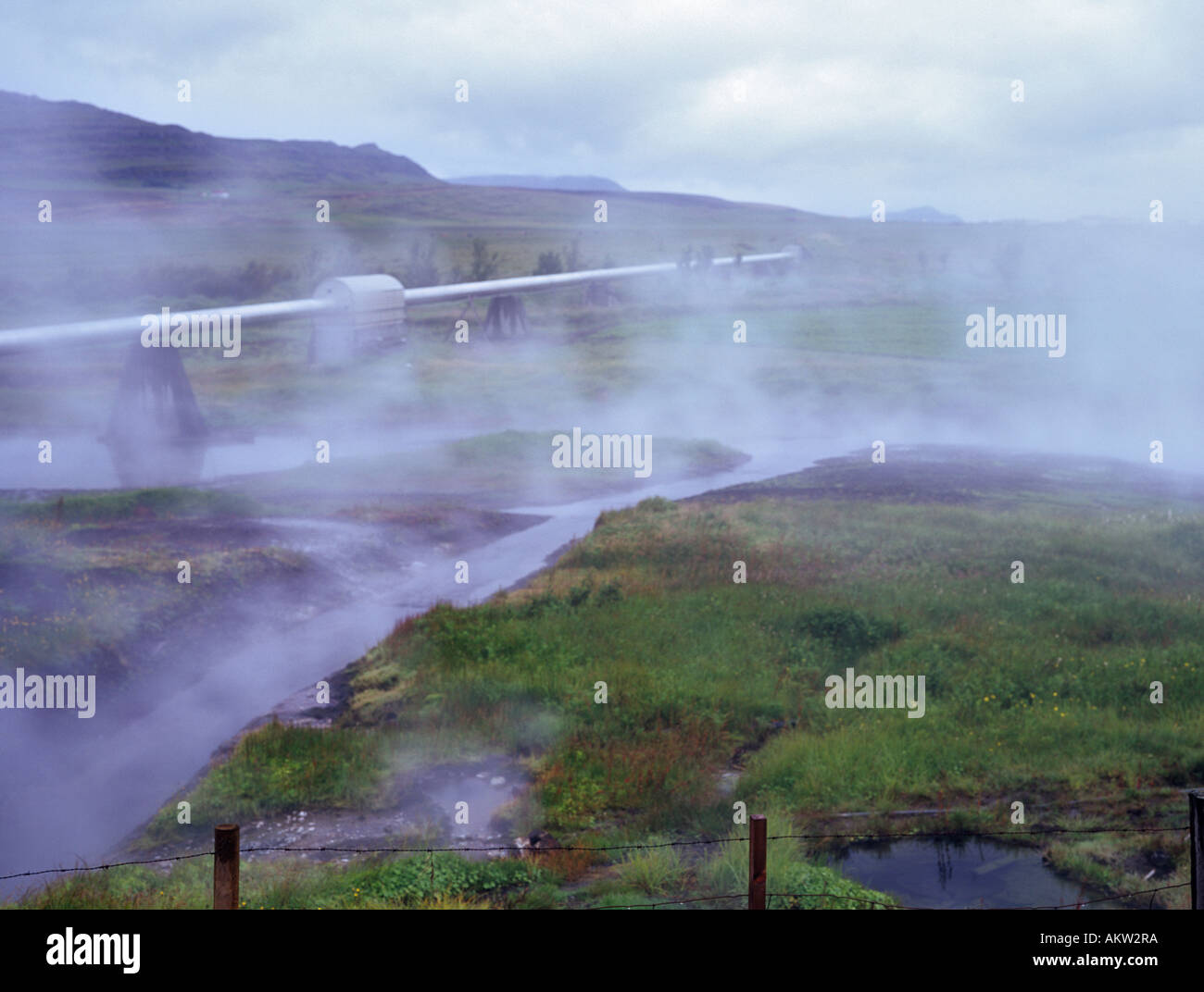 Deildartunguhver Iceland Steaming landscape from hot spring and water pipes carring geothermically heated hot water to Borgarnes Stock Photo