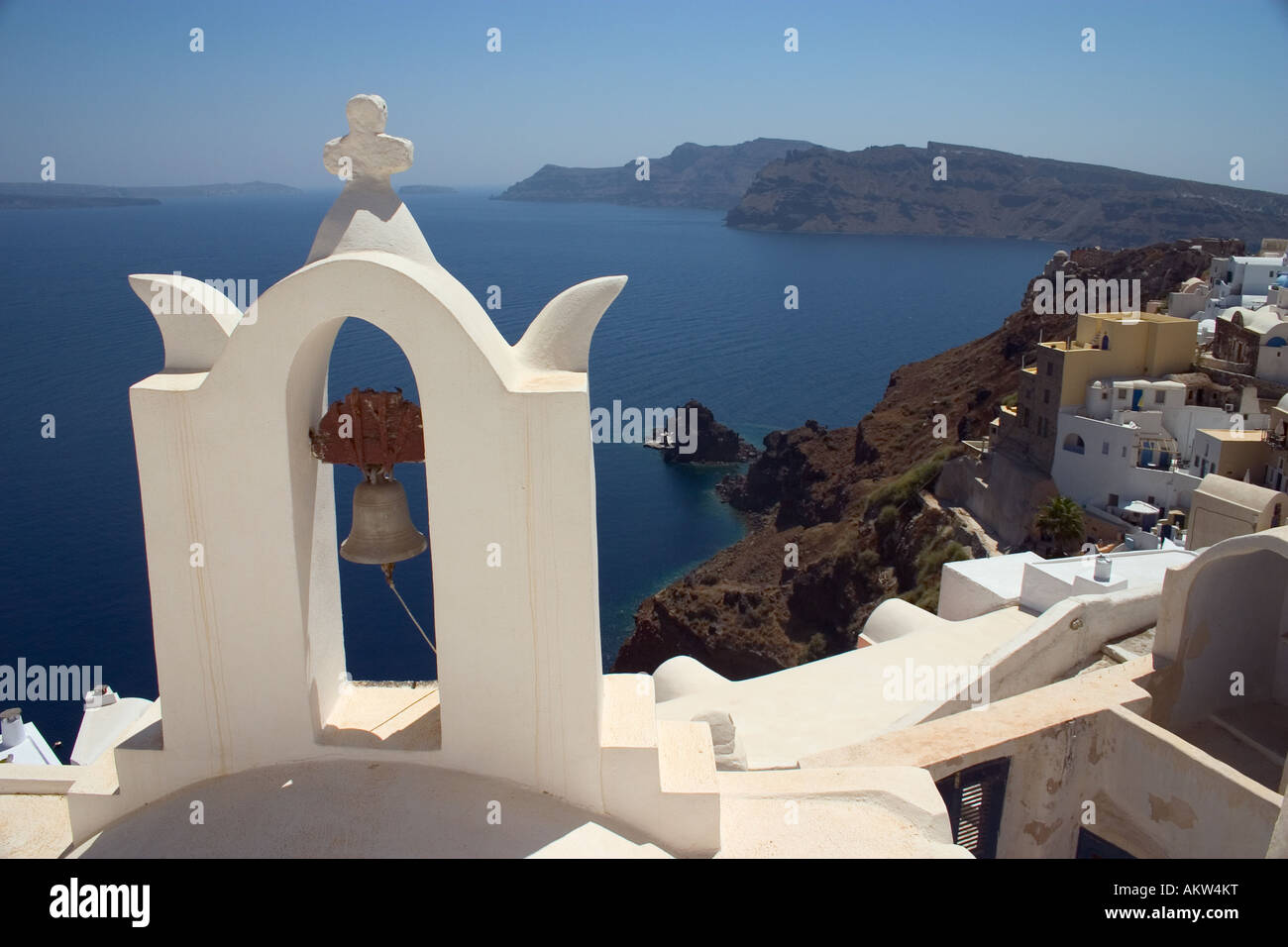 View of one of the famous churches in Oia or Ia on Santorini looking out across the volcanic caldera or lagoon Stock Photo