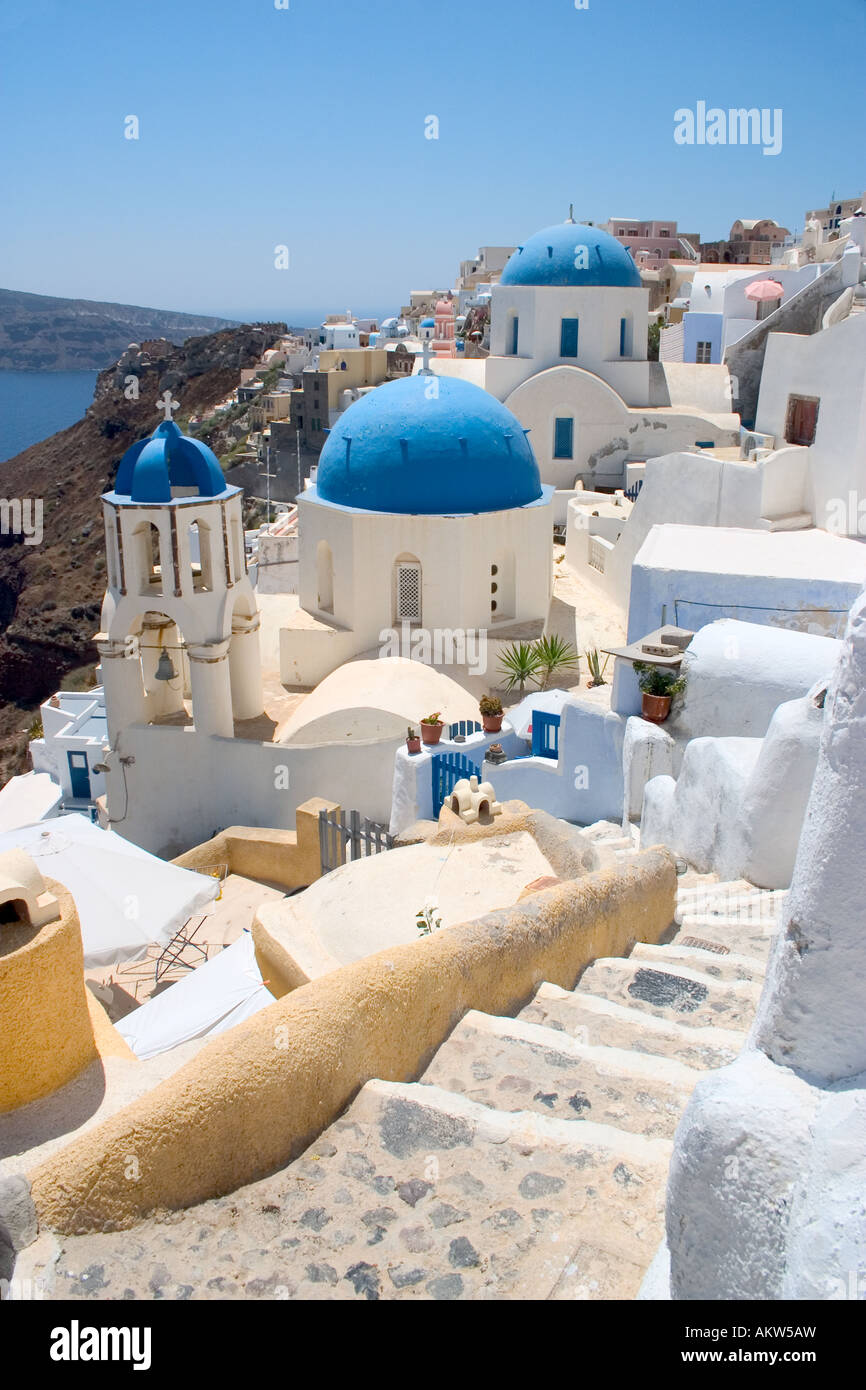 View of one of the famous churches in Oia or Ia on Santorini looking out across the volcanic caldera or lagoon Stock Photo