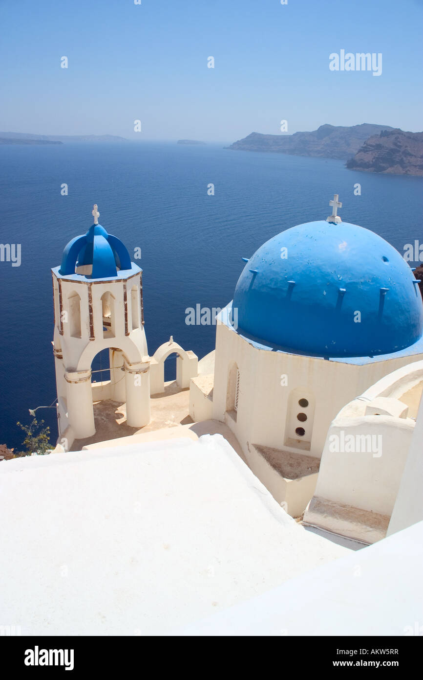 View of one of the famous churches in Oia or Ia on Santorini looking out across the volcanic caldera or lagoon Stock Photo
