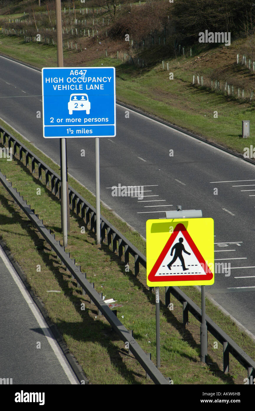 Road signs for High occupancy vehicle lane and pedestrian crossing Leeds England Stock Photo