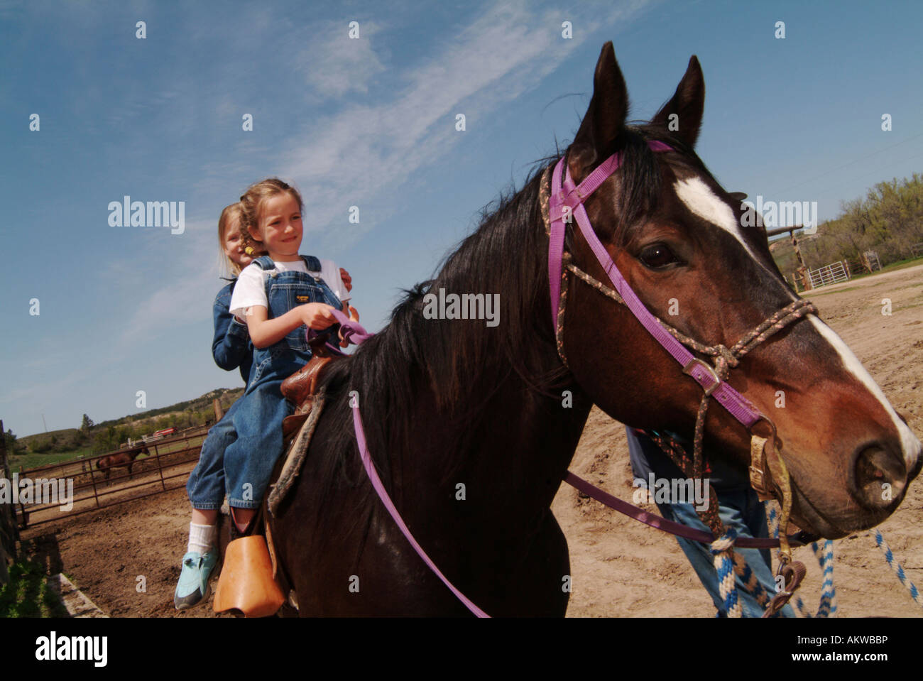 Girls riding a horse on Logging Camp Ranch North Dakota Stock Photo