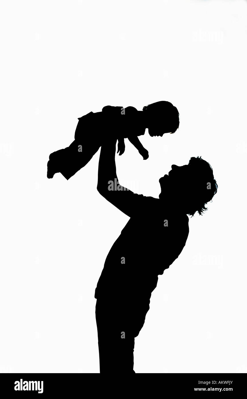 Man lifting child, silhouette Stock Photo