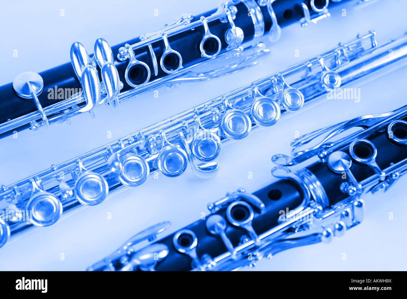 Two Clarinets and a silver flute in blue Stock Photo