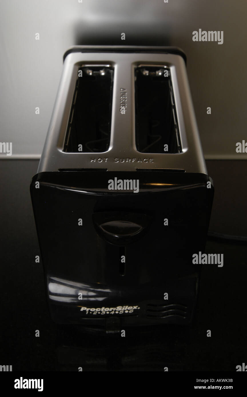 A chrome toaster on a dark kitchen counter, Stock Photo