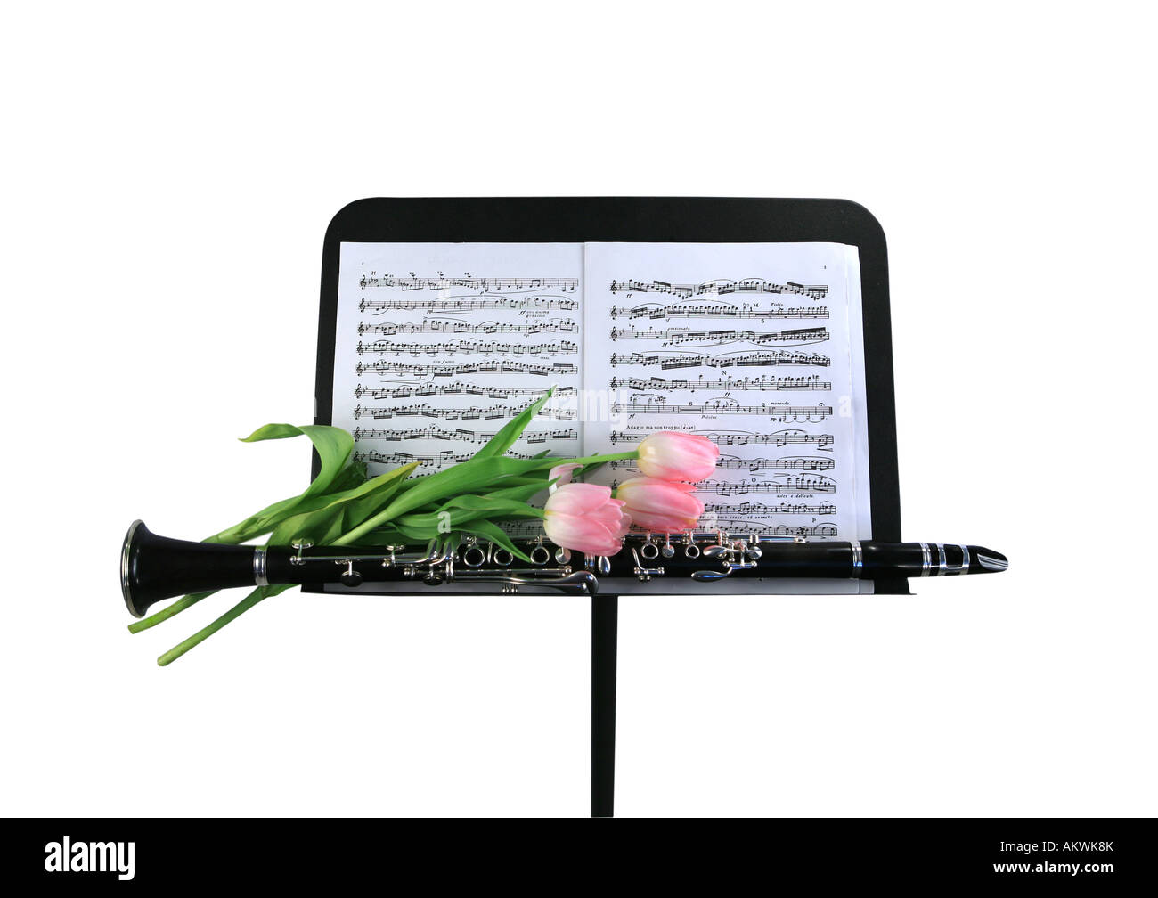 Clarinet on music stand with pink tulips isolated on white Stock Photo