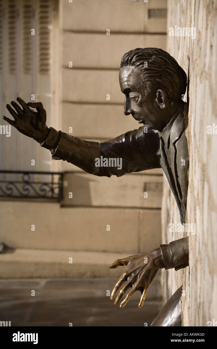 Statue of the writer and novelist Marcel Ayme entitled Passe Muraille sculped by Jean Marais Montmartre Paris France Stock Photo
