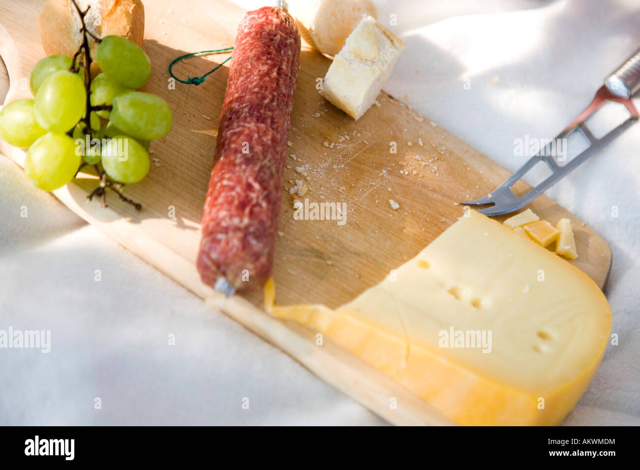 Sausage and cheese on chopping board Stock Photo - Alamy
