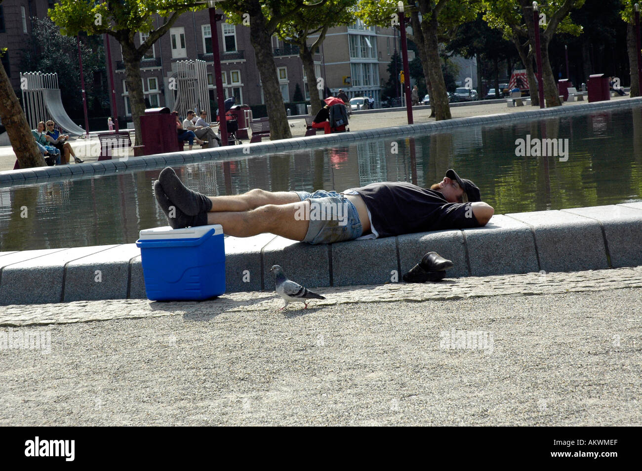 Man laid on his back sleeping in the sun on the Musemstraat Amsterdam ...