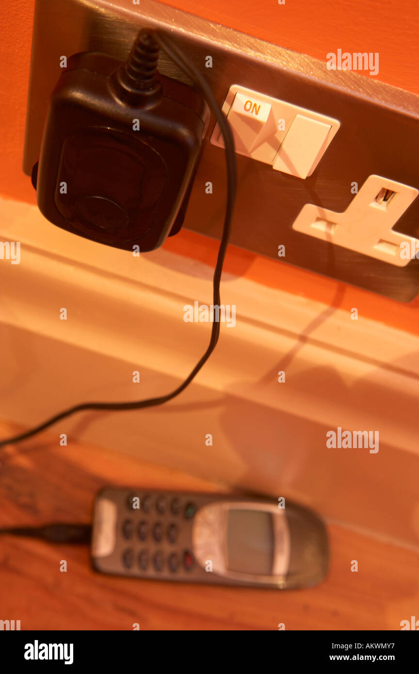 MOBILE PHONE CHARGER PLUGGED INTO 13 AMP MAINS SOCKET Stock Photo Alamy