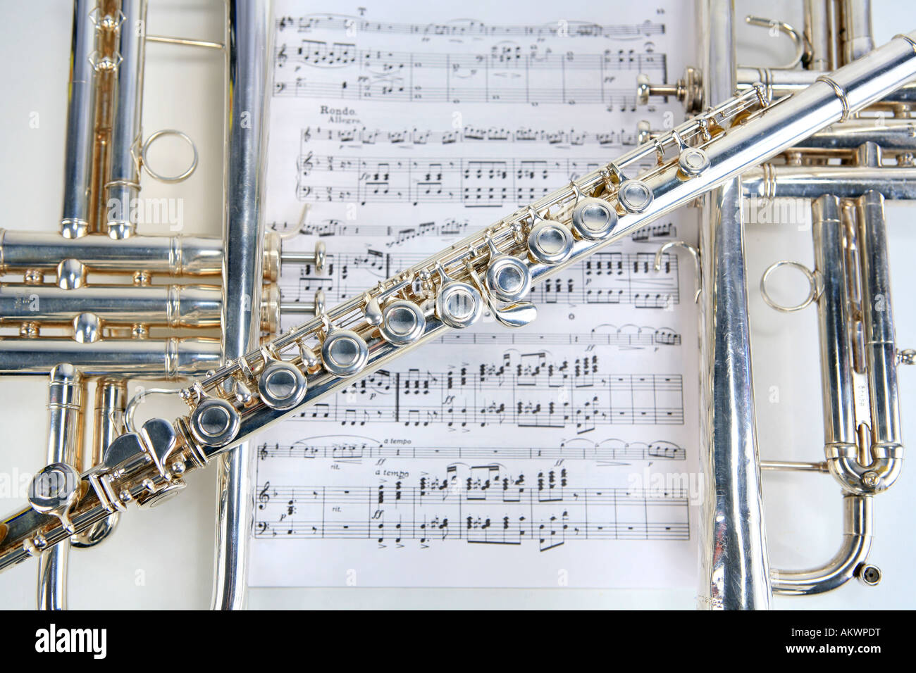 Two trumpets and flute on top of sheet music Stock Photo